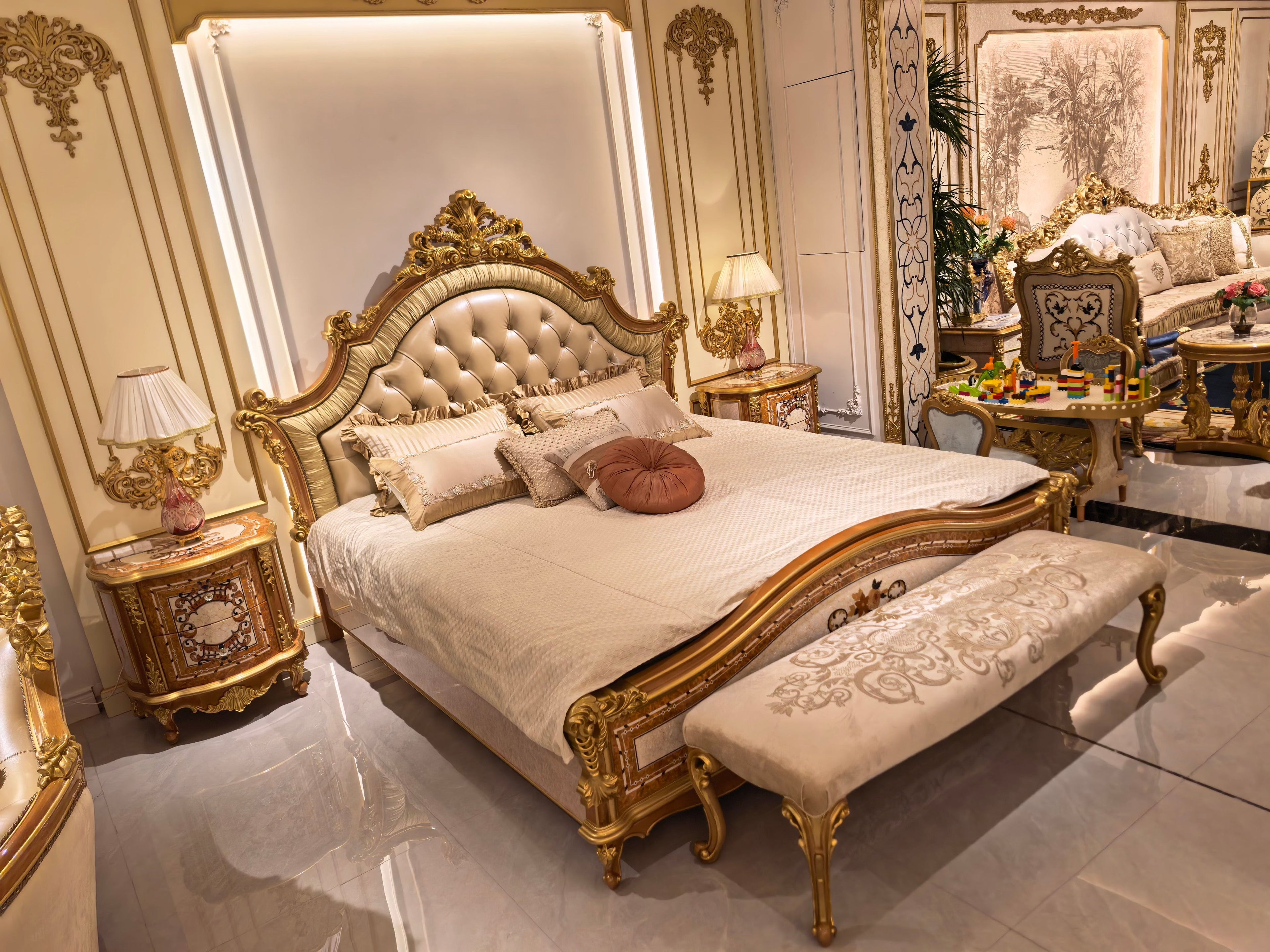 Colette French Imperial bedside table hand-carved corner detail, matching bed in background - GrandLiving Luxe