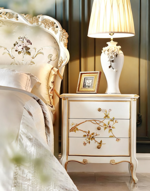 GrandLiving Luxe French Provincial solid wood bedside table featuring hand-carved detailing, hand-painted floral art, and gold leaf accents.